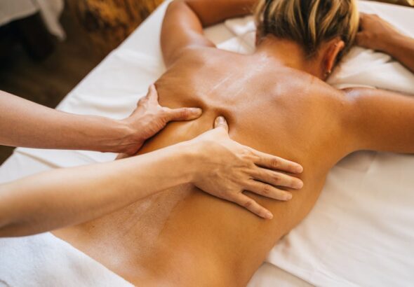 Free A Person Massaging a Client's Bare Back Stock Photo